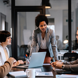 Business-woman-heading-meeting-around-table.jpg