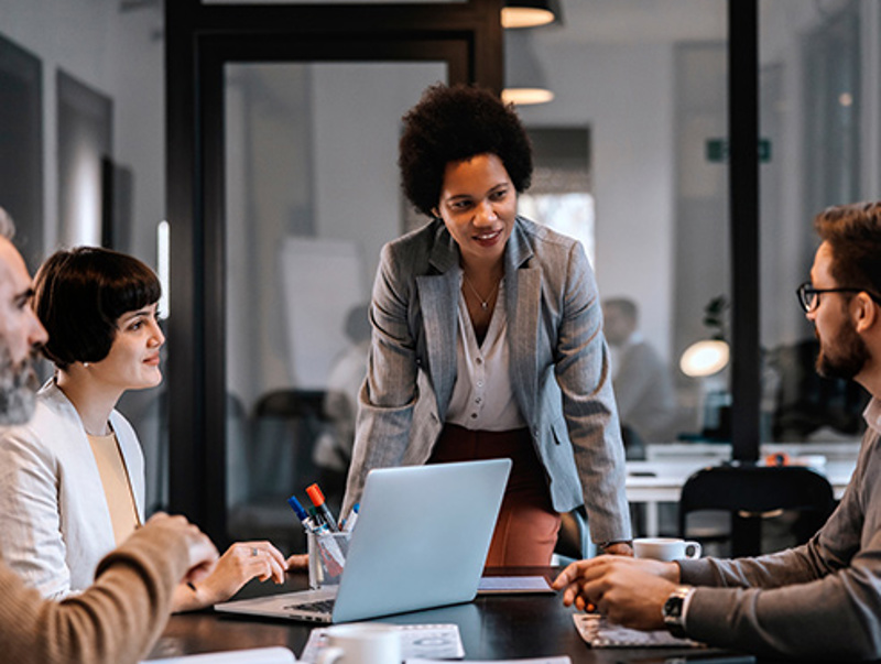 Business-woman-heading-meeting-around-table.jpg